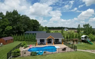 Aerial view of the pool house addition in Akron, NY, showcasing the surrounding landscape and custom millwork details by Stately General Contracting.