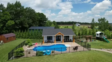 Aerial view of the pool house addition in Akron, NY, showcasing the surrounding landscape and custom millwork details by Stately General Contracting.