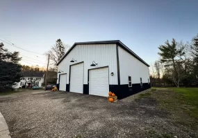 Landscape view of a Stately Pole Barns’ modern pole barn blending seamlessly into Holland, NY’s serene countryside.