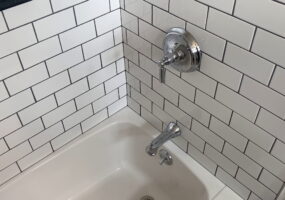 Chrome fixtures and expertly-installed subway tile by Stately Kitchen and Bath in Kenmore, NY.