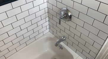 Chrome fixtures and expertly-installed subway tile by Stately Kitchen and Bath in Kenmore, NY.