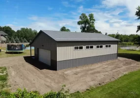 Post frame pole barn garage with lean to and large overhead doors – constructed by Stately Post Frame in Clarence Center, NY.