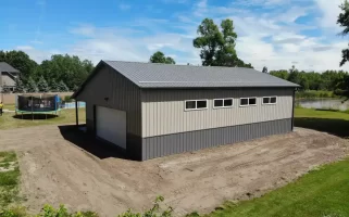 Post frame pole barn garage with lean to and large overhead doors – constructed by Stately Post Frame in Clarence Center, NY.