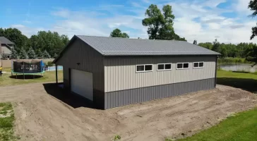 Post frame pole barn garage with lean to and large overhead doors – constructed by Stately Post Frame in Clarence Center, NY.