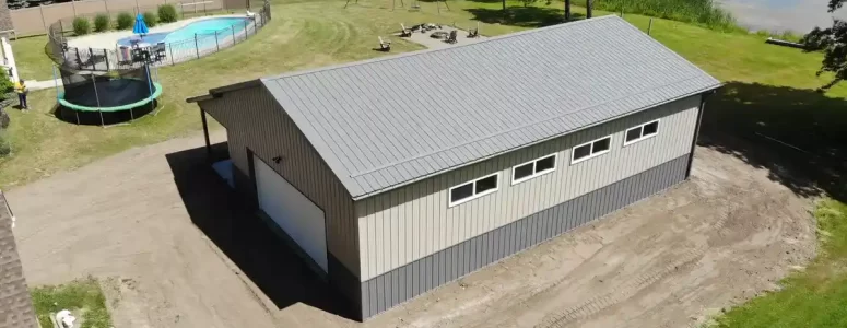 Post frame pole barn garage with lean to and large overhead doors – constructed by Stately Post Frame in Clarence Center, NY.